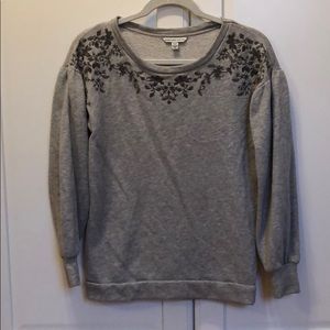 Embroidered floral gray sweater.